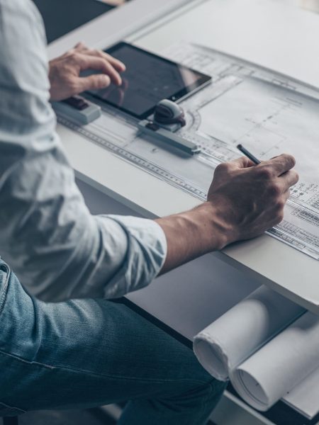 Young architect with a tablet and tools in the workplace